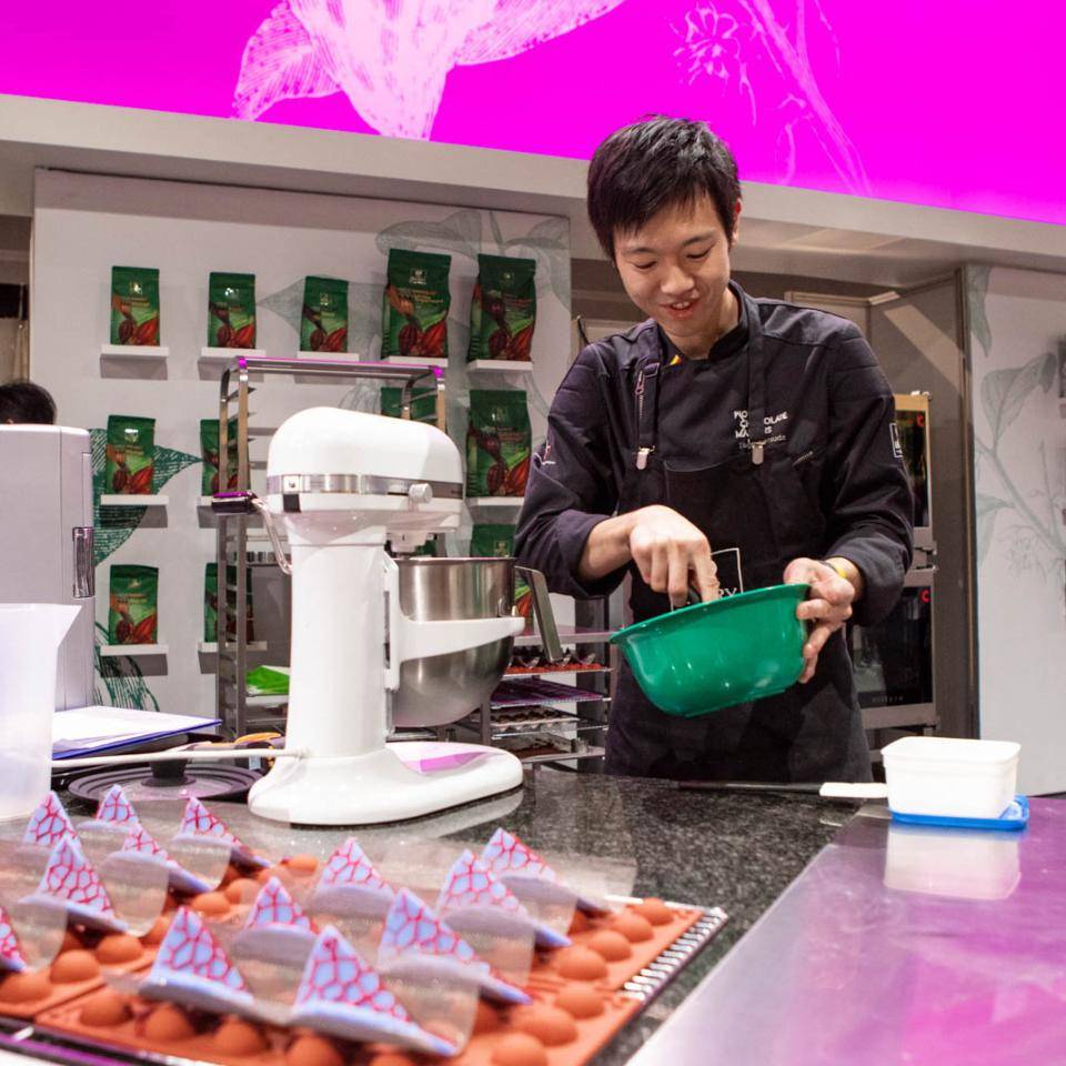 A chef-finalist works on his entry using a KitchenAid mixer
