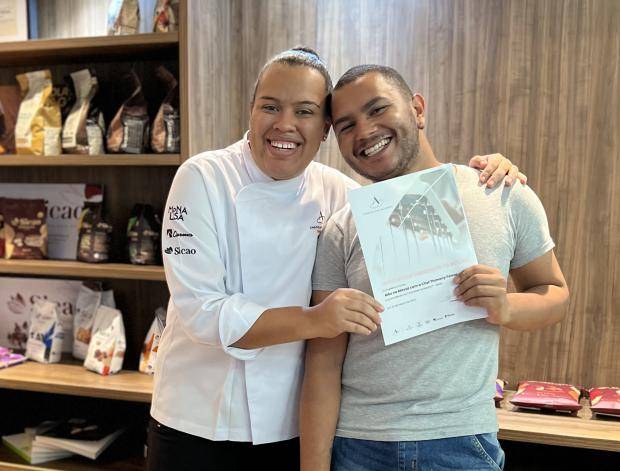 Chef entregando certificado de conclusão de curso para aluna