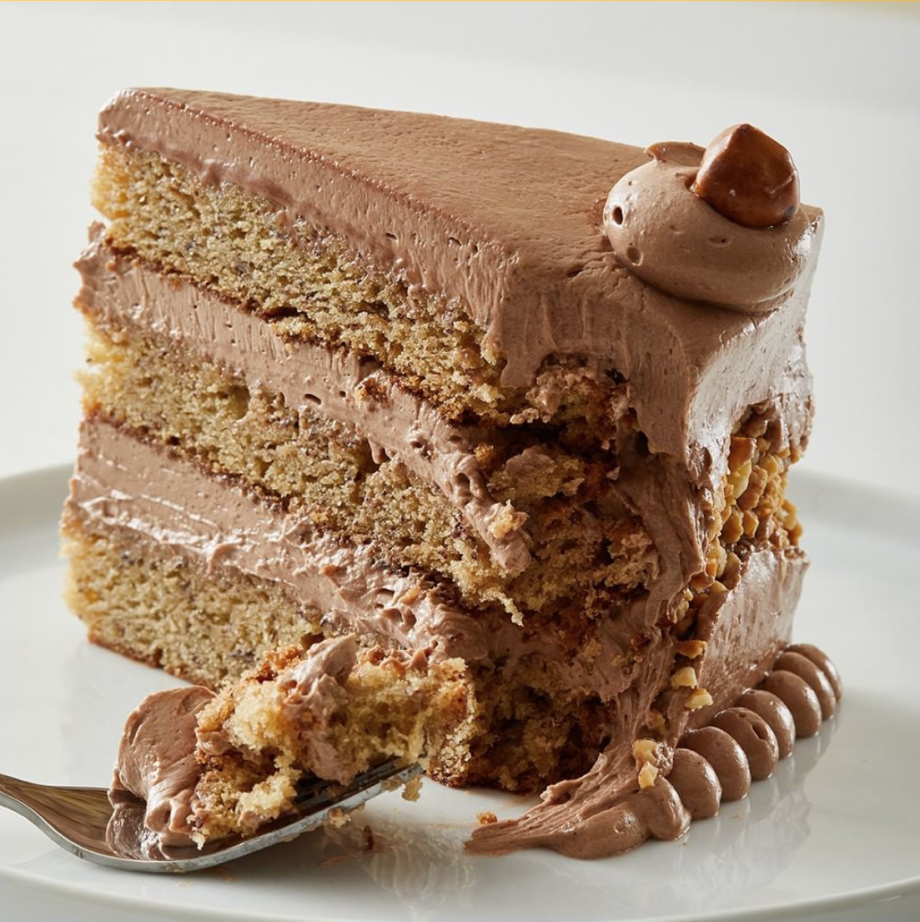 Slice of banana layer cake with milk chocolate ganache