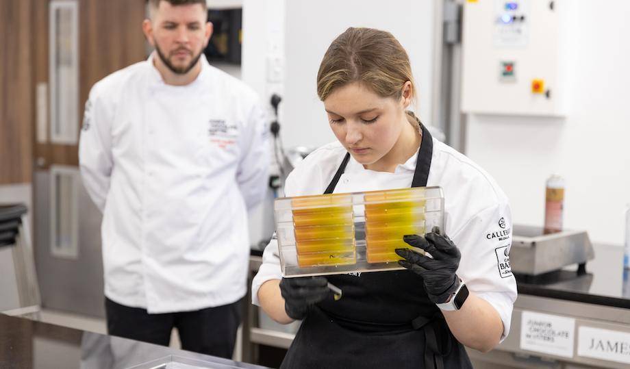 Mignon sprays the molds for her snacking bar