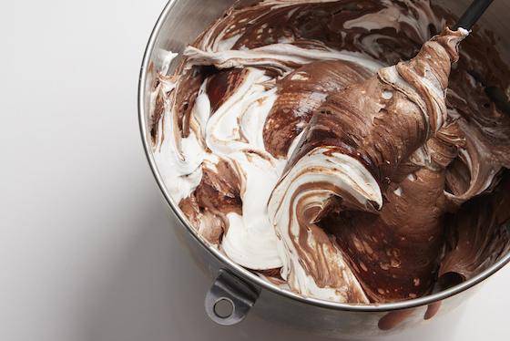 Cocoa powder being folded into a batter